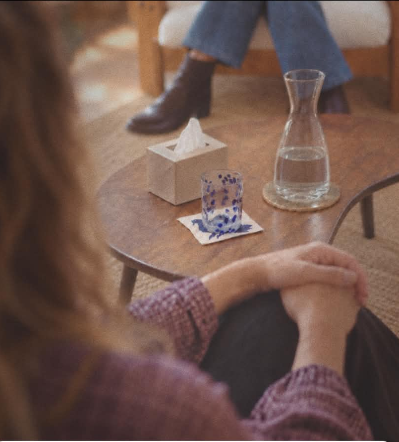 Therapy room in Fremantle with a glass of water and tissues on a low table